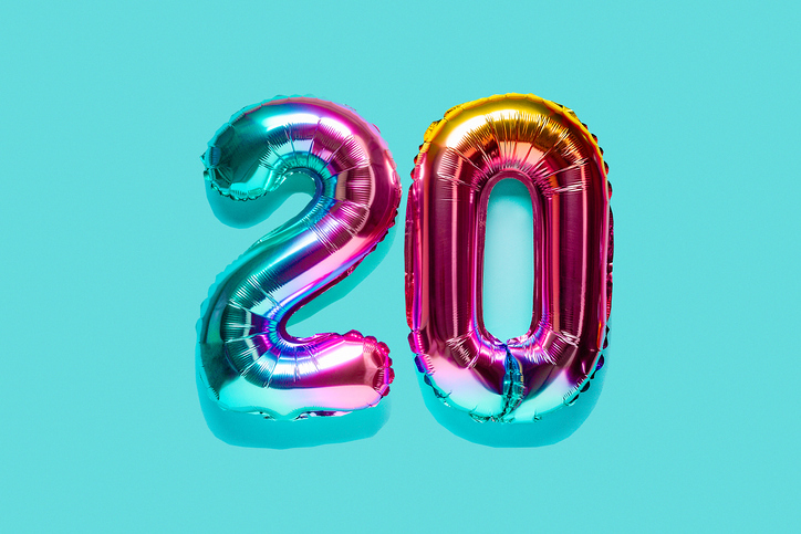 Rainbow foil balloon number, digit twenty. Top view. Colored numeral on blue background.