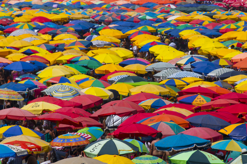 Beach umbrellas at a crowded beach on a sunny day in Lima (Costa Verde)