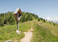 Summer view of the Göma Joch (Passo Goma) in the beautiful Italian Dolomites in Villnöß tVillnöss) during summer. Typical little mountain chapel. Alpine hiking path on a grassy mountain ridge.