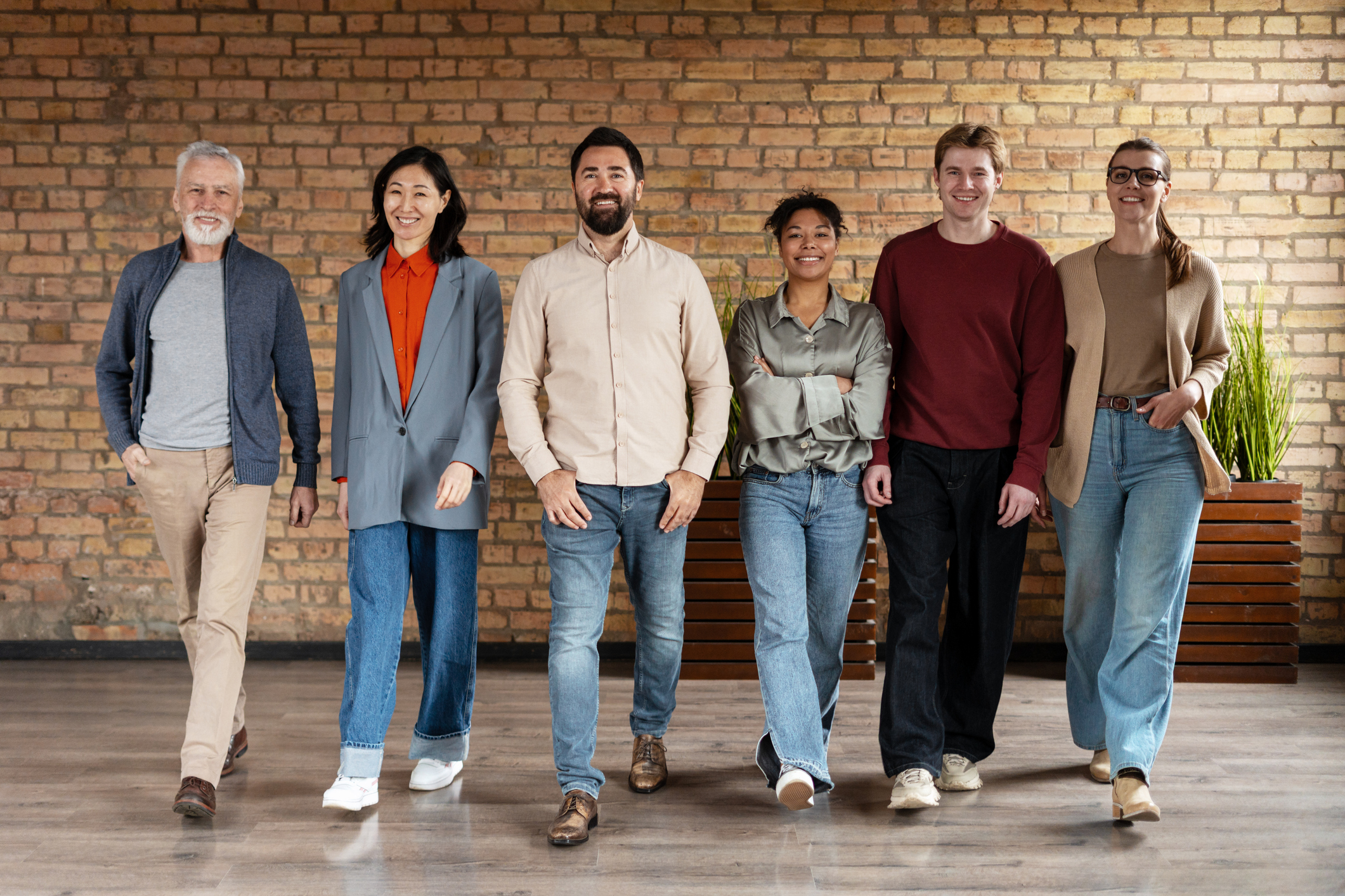 Diverse team of professionals is walking together in a modern office space, showcasing teamwork and collaboration