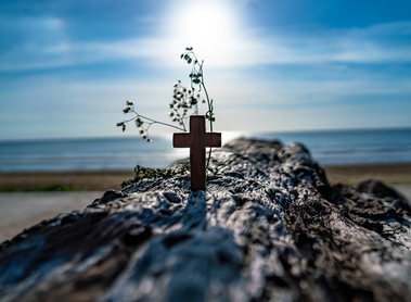 The wooden cross on the beach