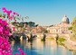 St. Peter's cathedral over bridge and river with flowers in Rome, Italy