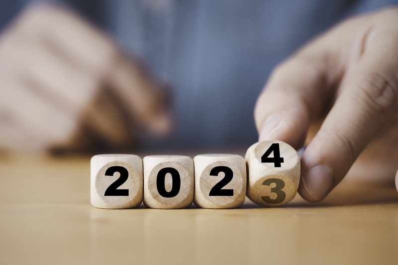 Hand flipping of 2023 to 2024 on wooden block cube for preparation new year change and start new business target strategy concept.