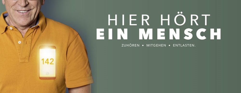 Lächelnder Mann, der ein Smartphone mit der Nummer 142 in der Nähe des Herzens hat