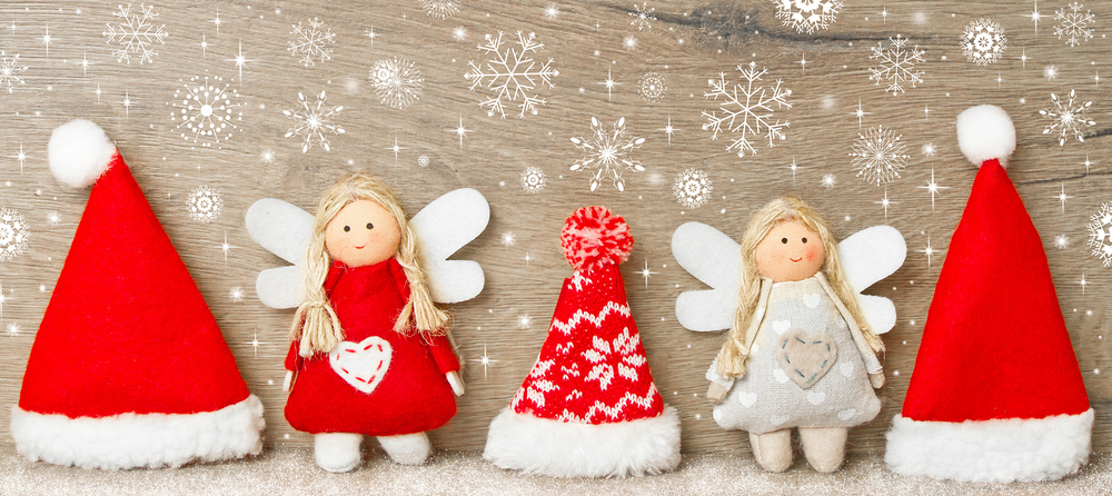 Background with cheerful christmas hats and angles figures